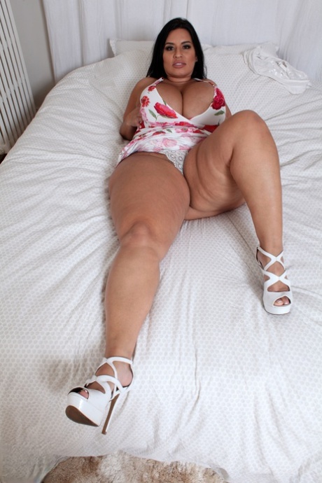 Chubby mature Sofia Rose lets out her huge juggs and rubs her twat on a bed