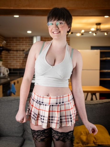 Short haired teen in glasses Kitty Kunt displays her big tits and bubble ass