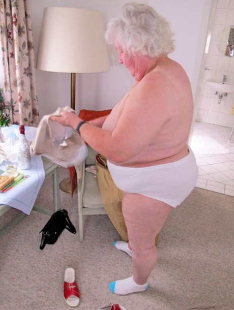 Chubby granny Marie Theres shows her big saggy tits & ass while changing