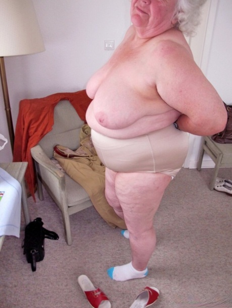 Chubby granny Marie Theres shows her big saggy tits & ass while changing