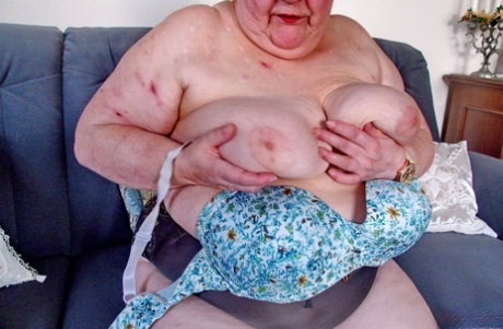 Chubby granny Marie Theres shows her big saggy tits & ass while changing